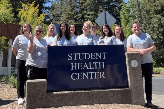 Photo of Student Health Center staff in front of SHC building