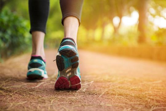 Photo of jogger on a trail.